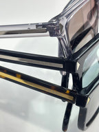 Prada eyeglasses close-up, black frame and temple hinge detail