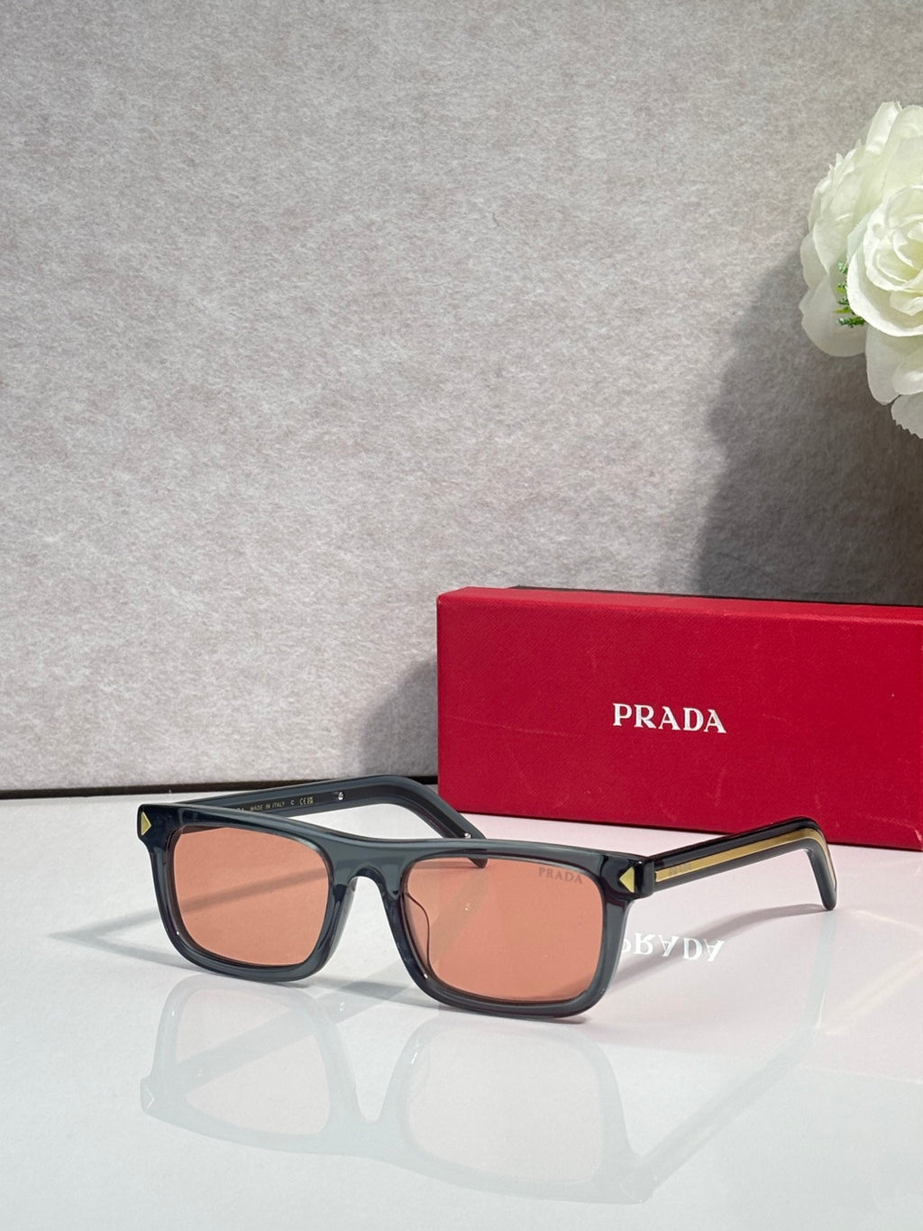 Prada rectangular eyeglasses, black frame, warm brown-tinted lenses