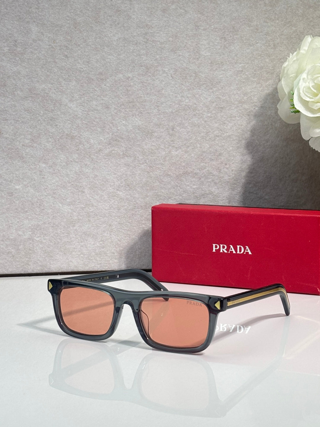 Prada rectangular eyeglasses, black frame, warm brown-tinted lenses