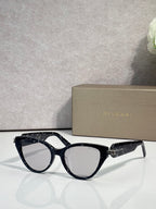 Bvlgari black cat-eye eyeglass frames with gold logo detail on temples