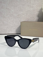 Bvlgari black sunglasses with dark lenses and gold logo on temple arms