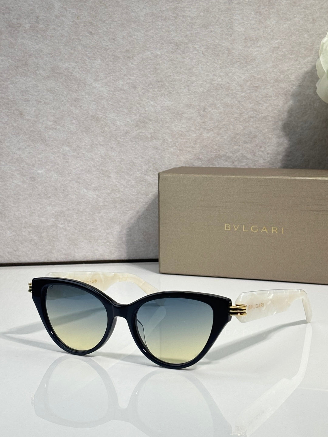 Bvlgari dark blue cat-eye eyeglass frames with gold logo on temples