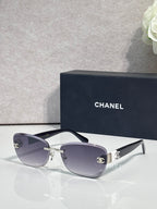 Sunglasses with dark gray frames, silver bridge, and gray tinted lenses