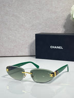Chanel sunglasses with gold-tone frame and green tinted lenses, green temples