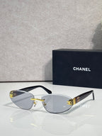 Chanel sunglasses with gold-tone frame and clear-to-brown gradient lenses, tortoise temples