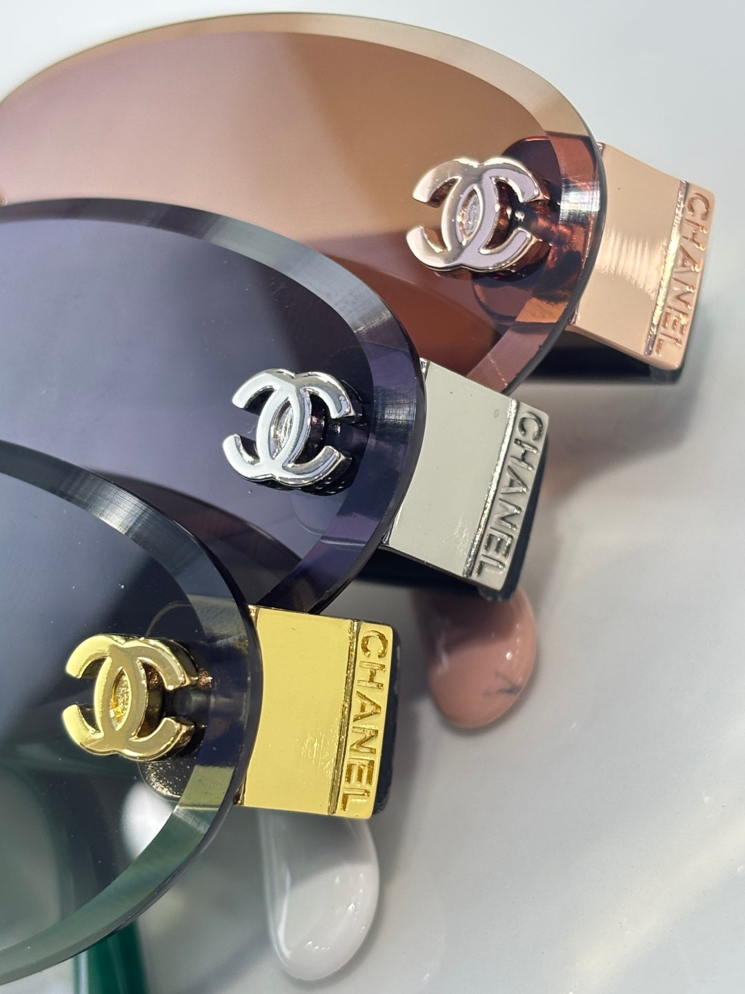 Chanel sunglasses close-up of gold bridge hardware and circular temple logo plates