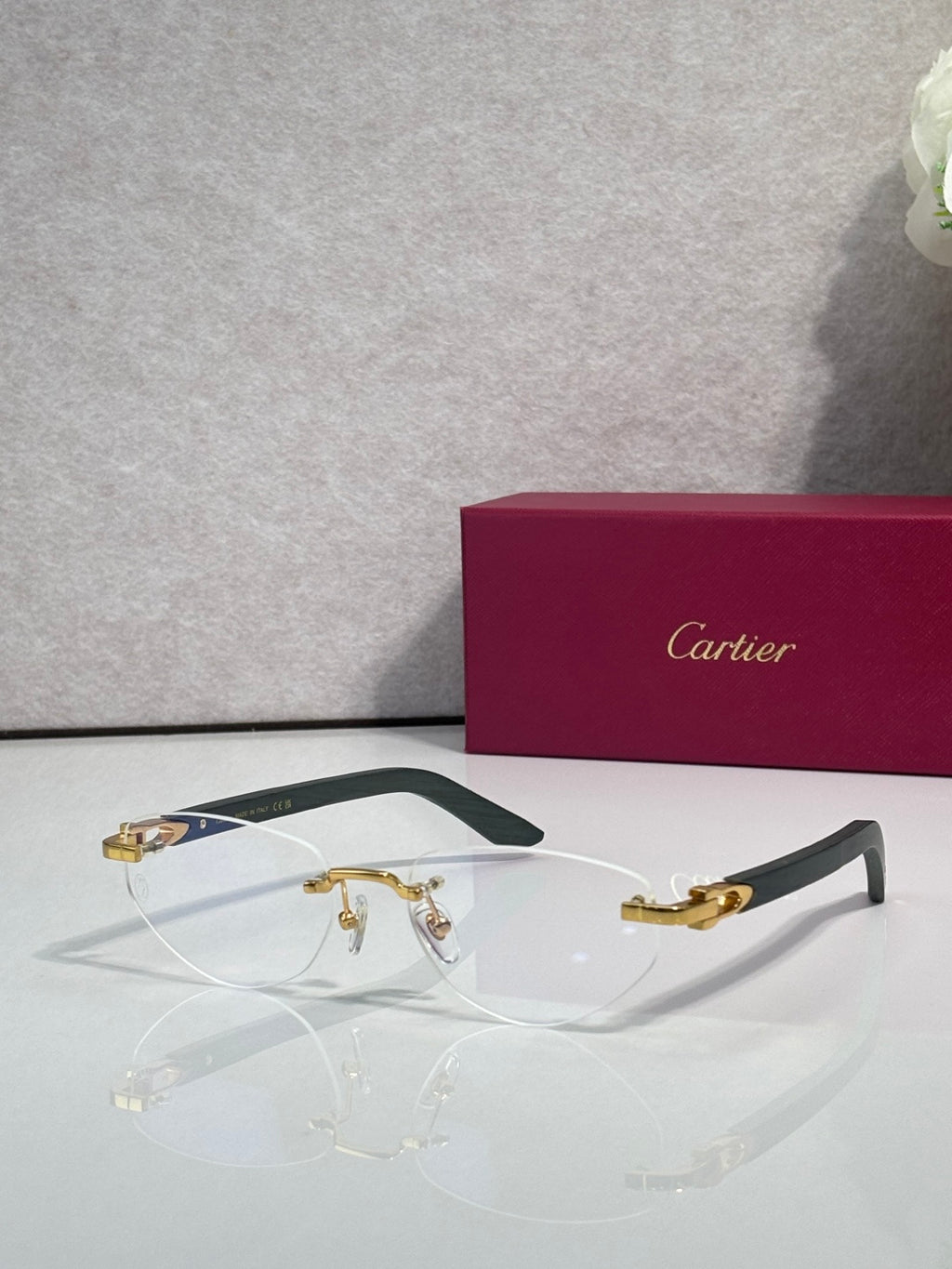 Eyeglasses with clear lenses, gold-tone metal frame and dark green temple accents