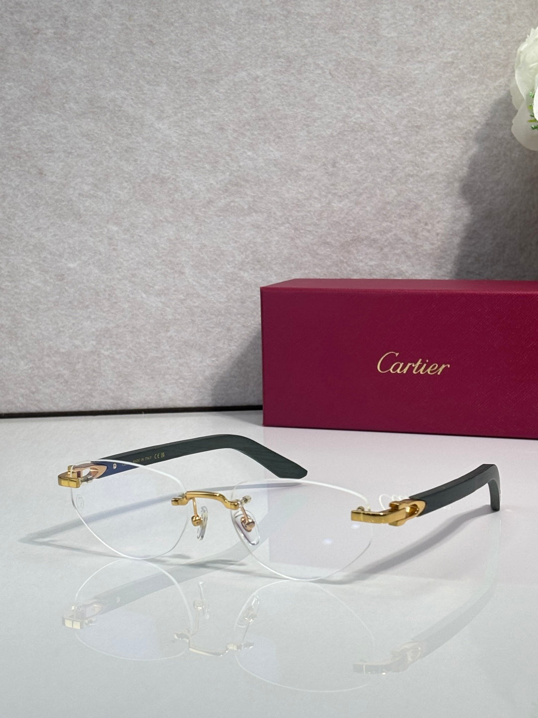 Eyeglasses with clear lenses, gold-tone metal frame and dark green temple accents