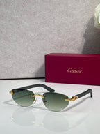 Cartier sunglasses with green tinted lenses and gold-tone frame with metal hinge details