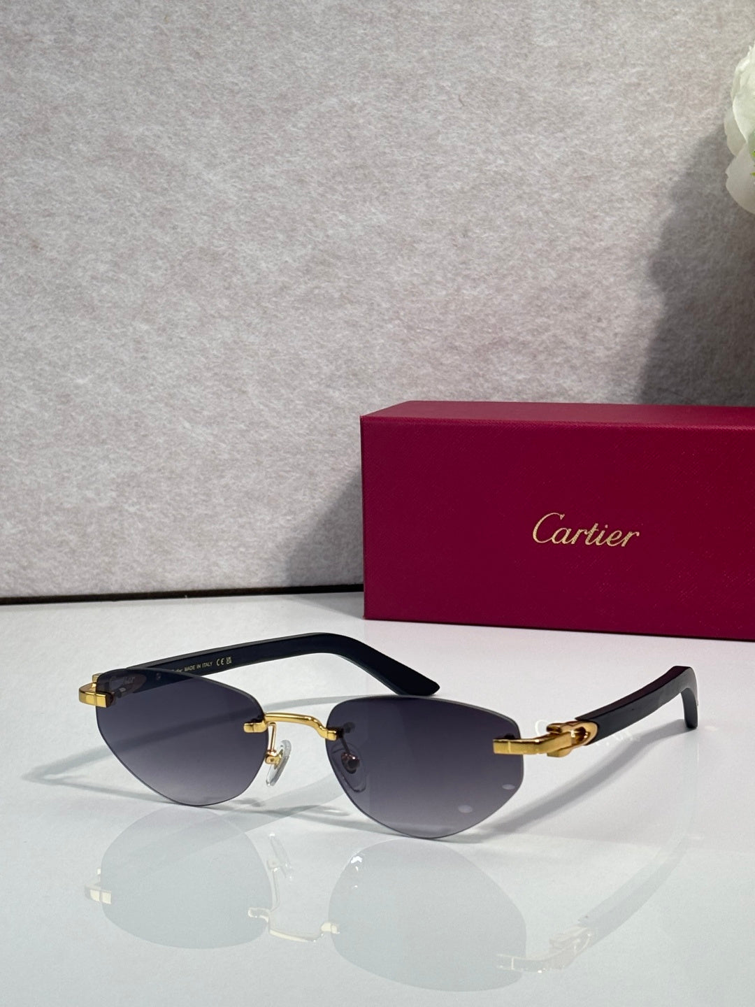 Cartier sunglasses with dark blue lenses and silver frame, gold accents and dark temples