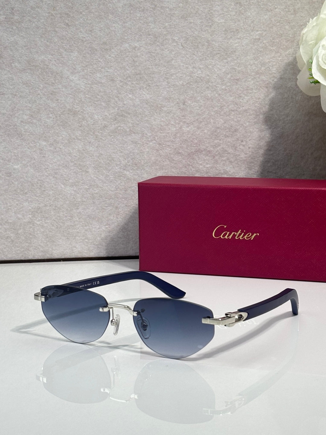 Cartier sunglasses with dark blue lenses and silver frame, gold accents and temples