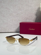 Cartier sunglasses with amber tinted lenses and gold-tone frame, dark temple tips