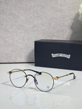 Round eyeglasses with dark blue frame and gold-tone ornate temples
