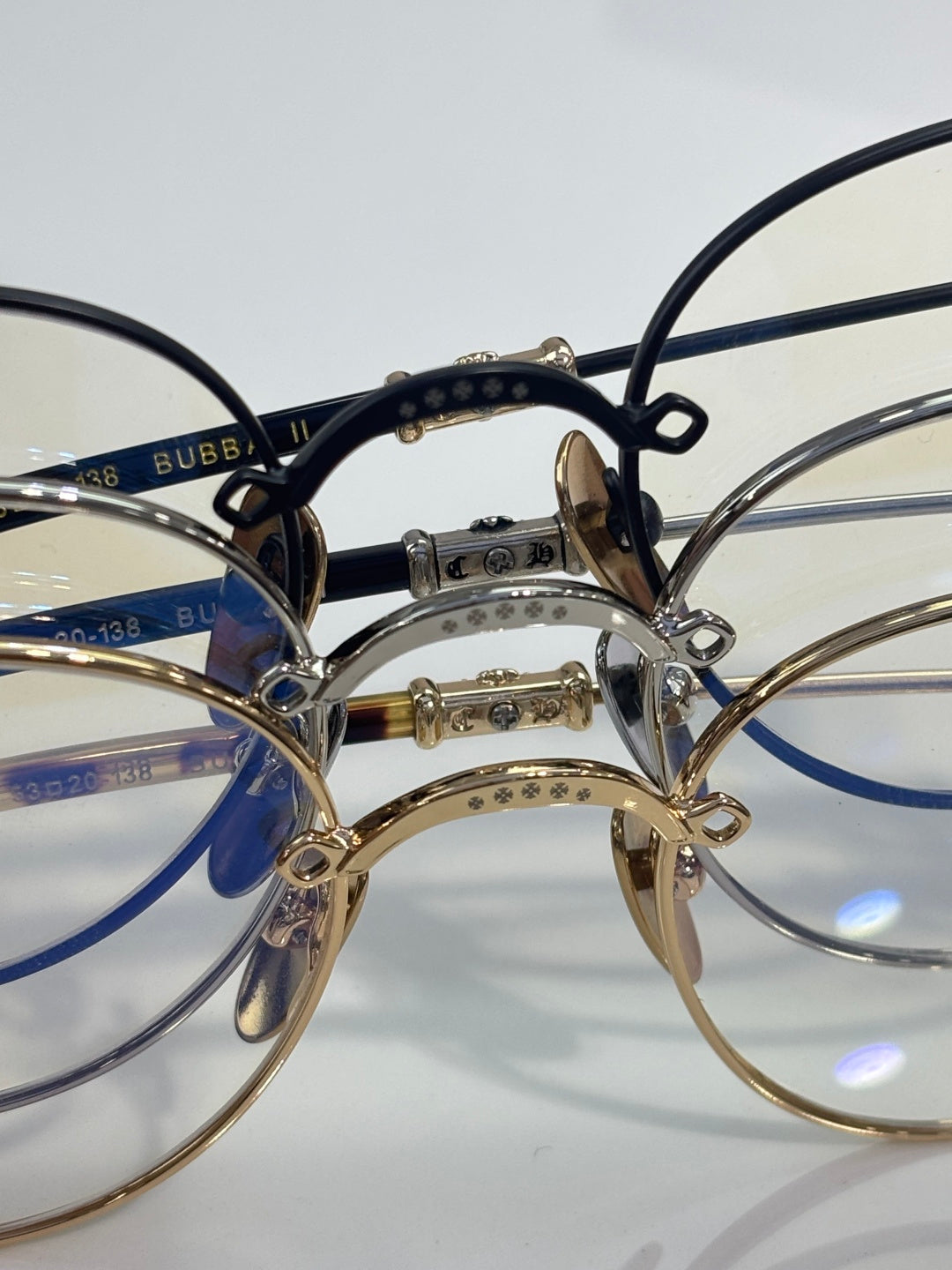 Round eyeglasses close-up with dark blue inner rim and gold-tone bridge