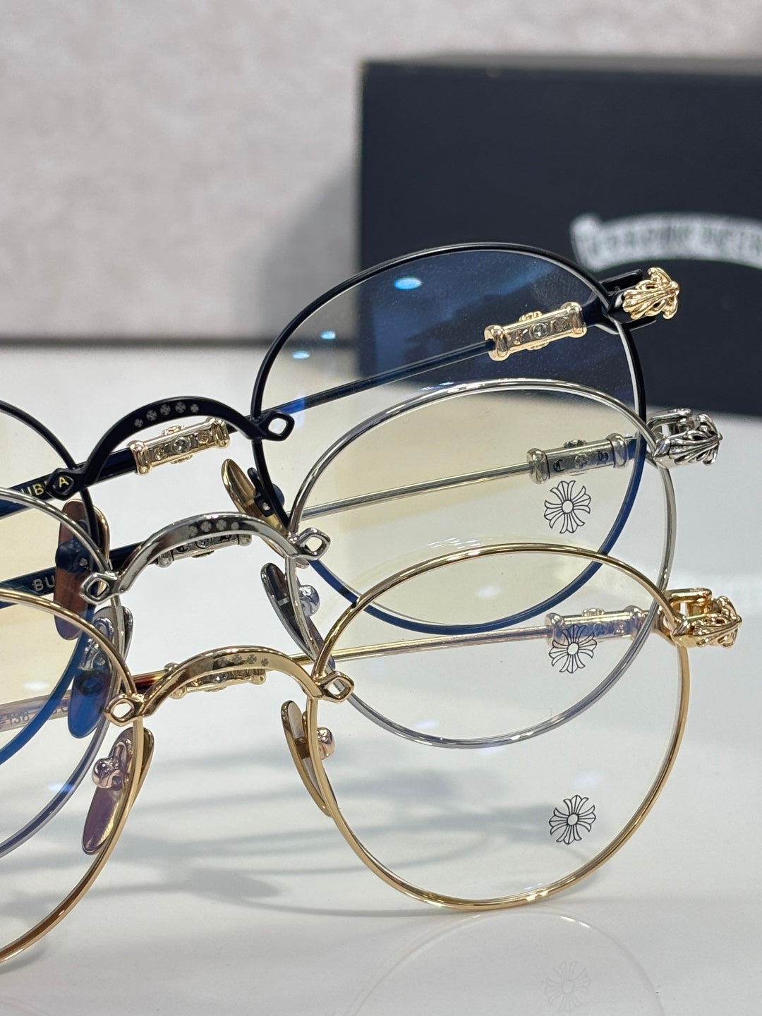Round eyeglasses close-up with gold-tone rims and clear lenses