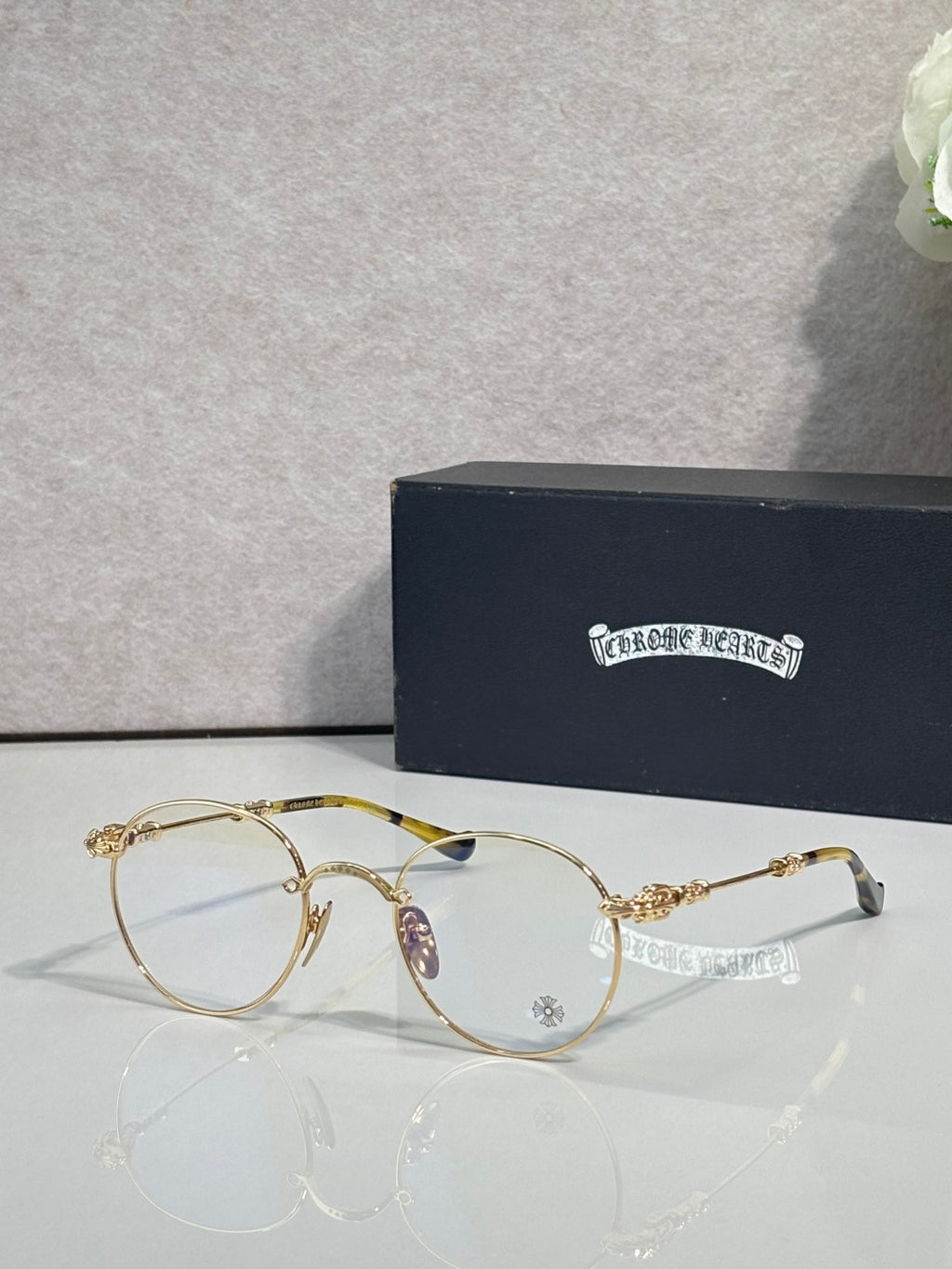 Round eyeglasses with thin gold-tone frame and clear lenses