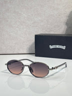 Chrome glasses with round mauve lenses and dark frames, clear temples.