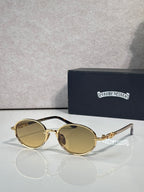 Chrome glasses with round amber lenses and gold frames, clear temples.