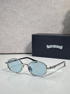 Chrome glasses with round light-blue lenses and black frames, clear temples.