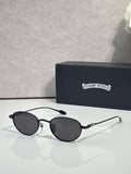 Round black sunglasses with dark lenses and slim chrome arms
