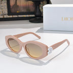 Dior sunglasses with pale pink frames and tinted lenses, featuring a white flower detail.
