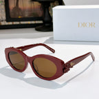 Dior sunglasses with red frames and brown tinted lenses, featuring a red flower detail.