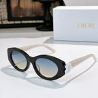 Dior sunglasses with black frames and blue tinted lenses, featuring a white flower detail.
