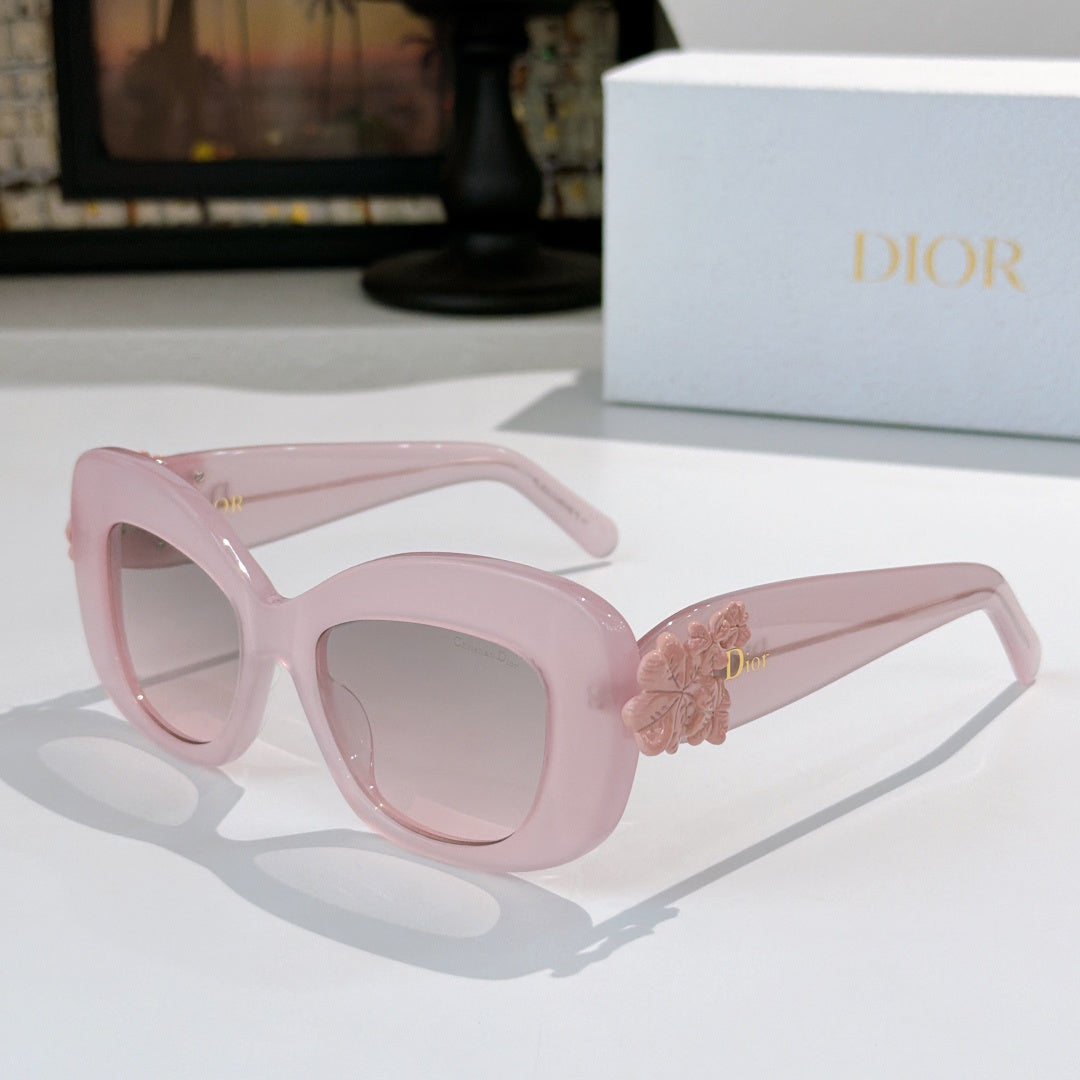 Dior sunglasses with pale pink frames and pink floral temple detail with tinted lenses