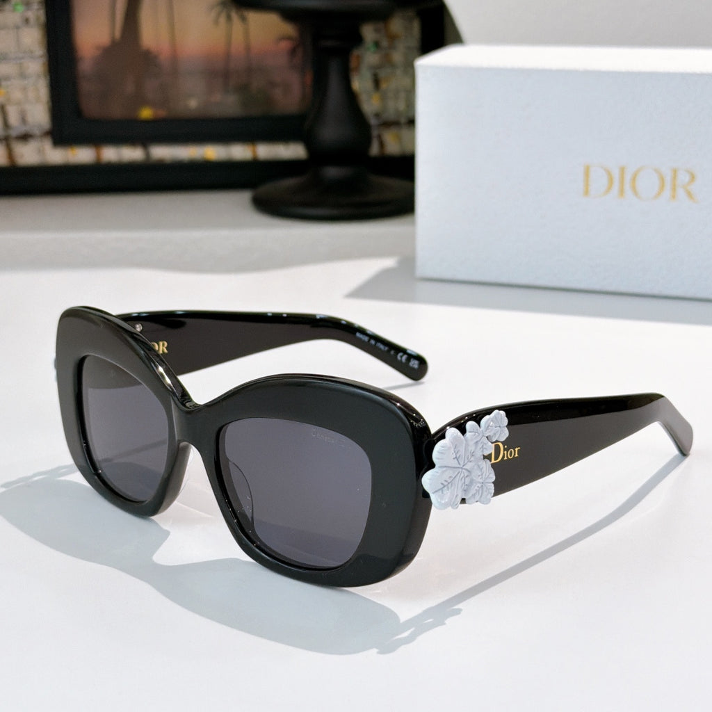 Dior sunglasses with black frames and pale blue floral temple detail with dark lenses
