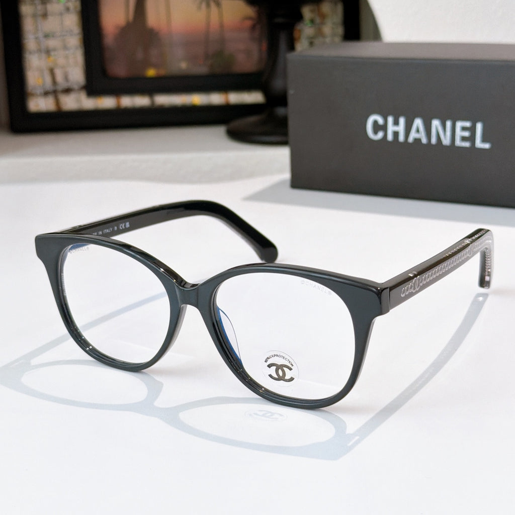 Black eyeglasses with round lenses and gold chain-style detail on the temple