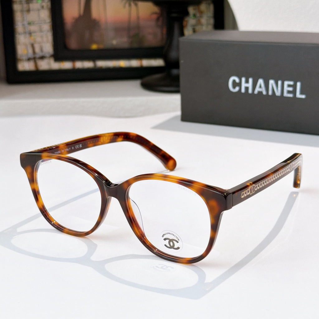 Tortoiseshell eyeglasses with round lenses and gold logo detail on the temple
