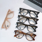 Set of peach and multiple black and brown eyeglasses with round frames