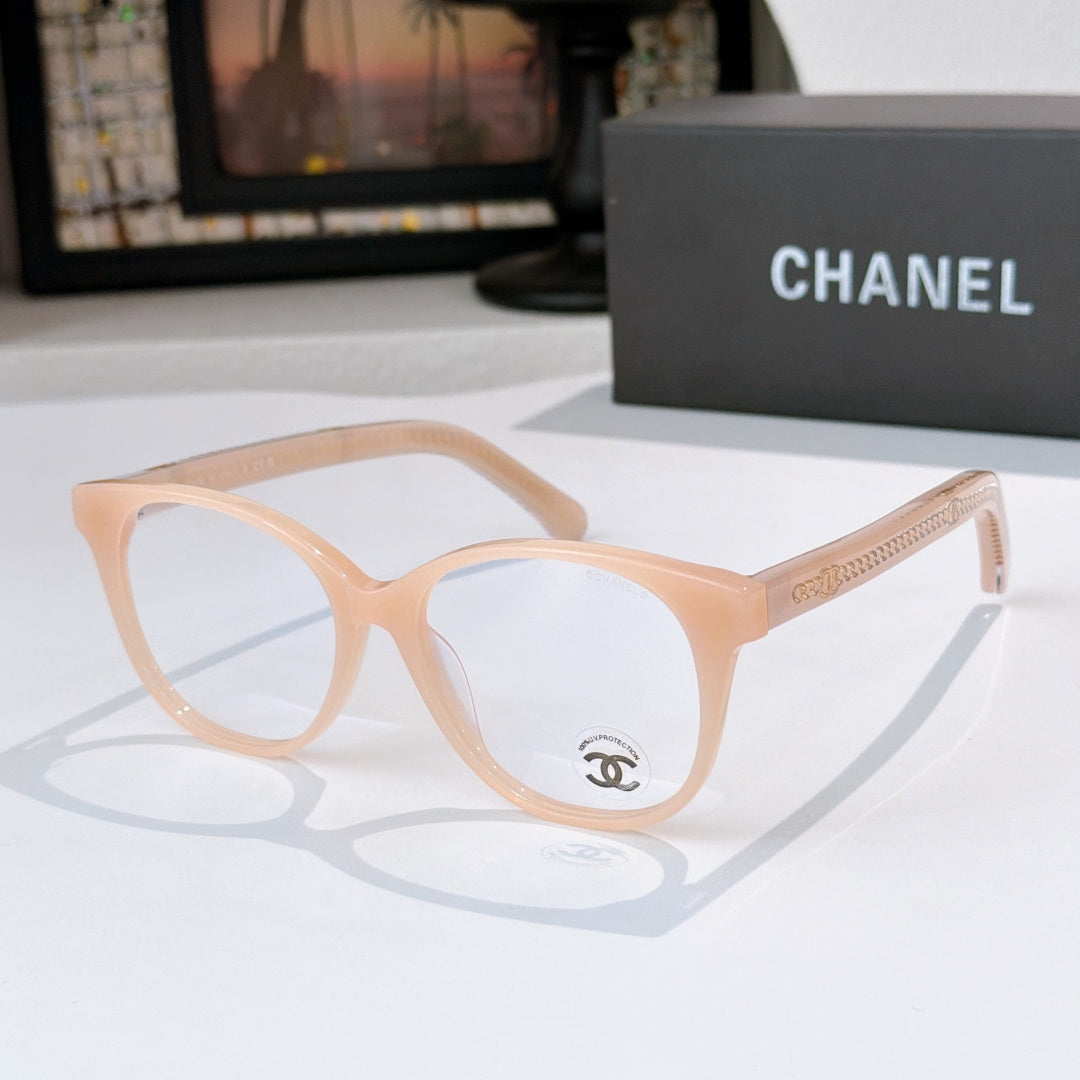 Light peach eyeglasses with round lenses and gold logo detail on the temple