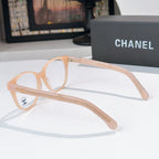 Light peach eyeglasses with round lenses and gold chain-style temple detail