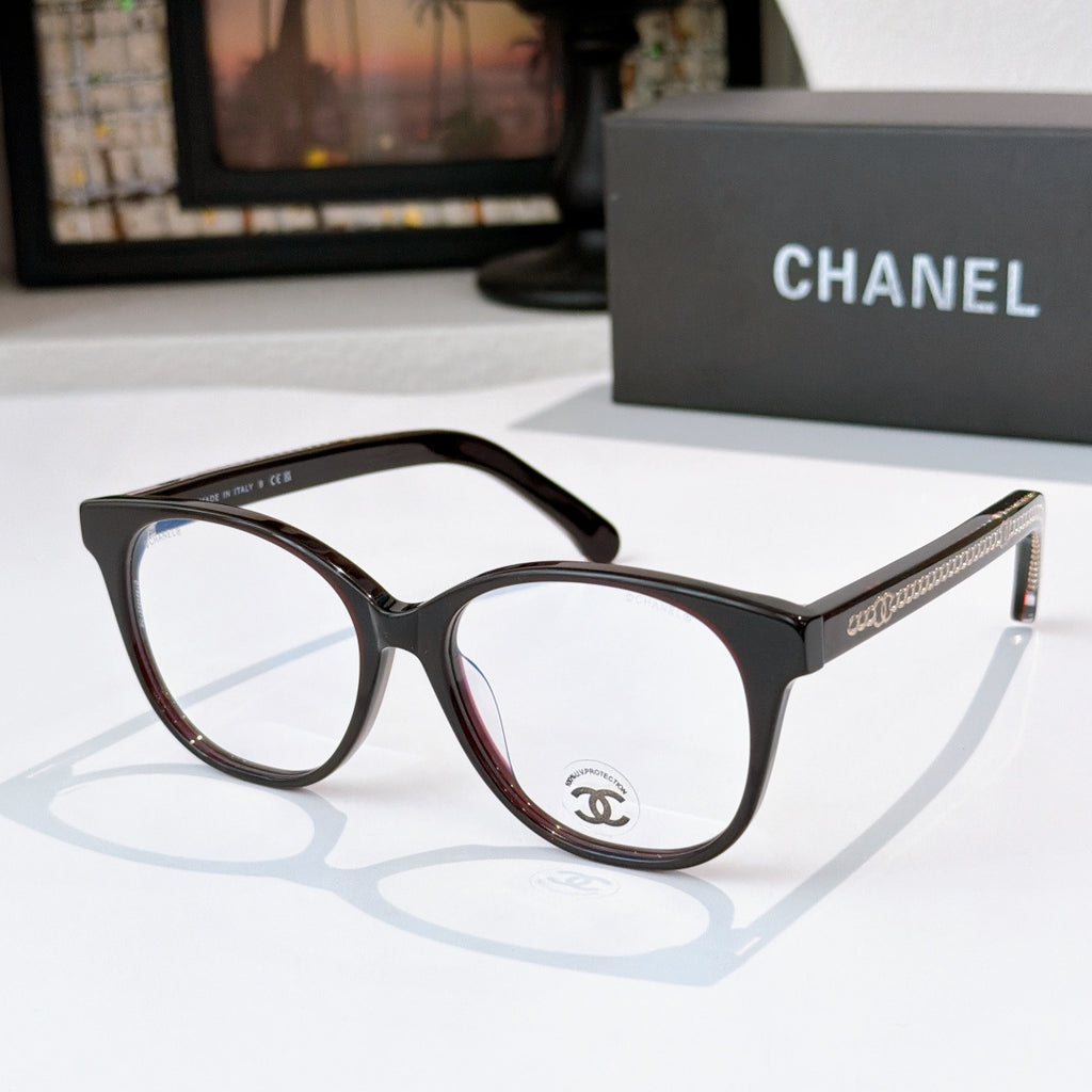 Black and brown gradient eyeglasses with round lenses and gold logo detail