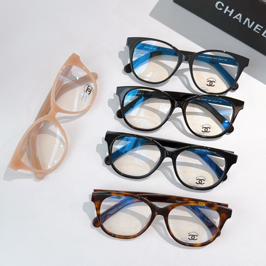Set of blue-tinted eyeglasses with black, tortoiseshell, and peach round frames
