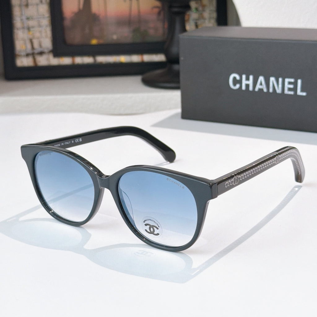 Chanel sunglasses with dark frames and blue tinted lenses, round oversized shape
