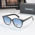 Chanel sunglasses with dark frames and blue tinted lenses, round oversized shape