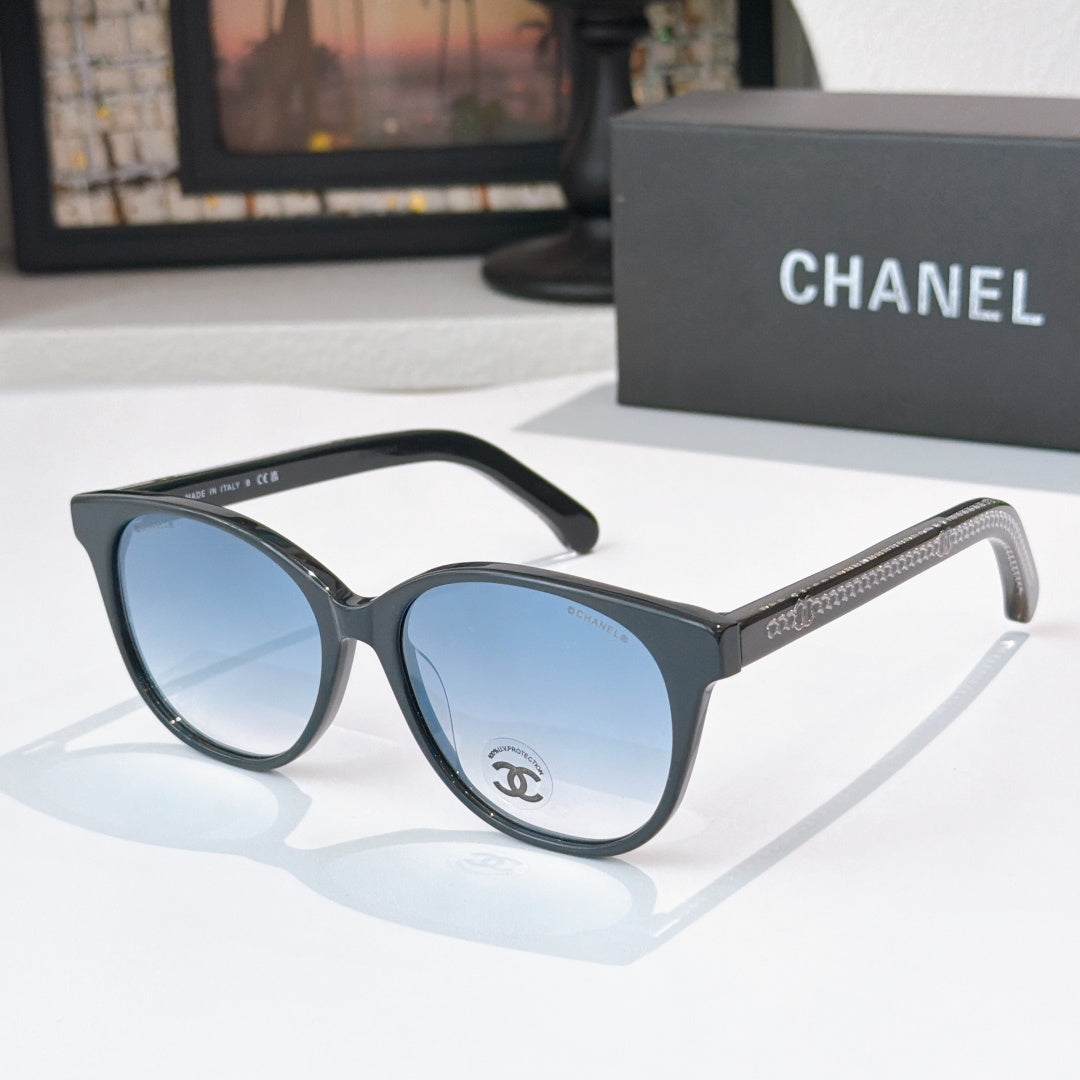 Chanel sunglasses with dark frames and blue tinted lenses, round oversized shape