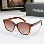 Chanel sunglasses with tortoiseshell frames and amber tinted lenses, round cat-eye