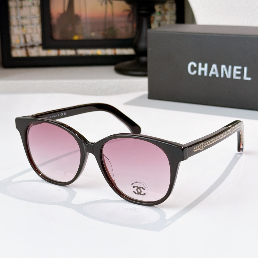 Chanel sunglasses with black frames and pink tinted lenses, round cat-eye style