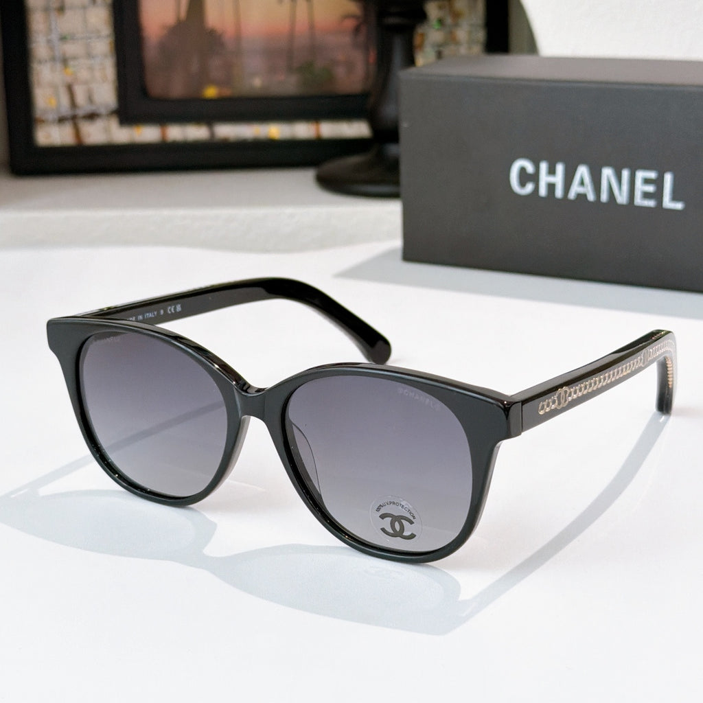 Chanel sunglasses with black frames and gray lenses, round cat-eye silhouette