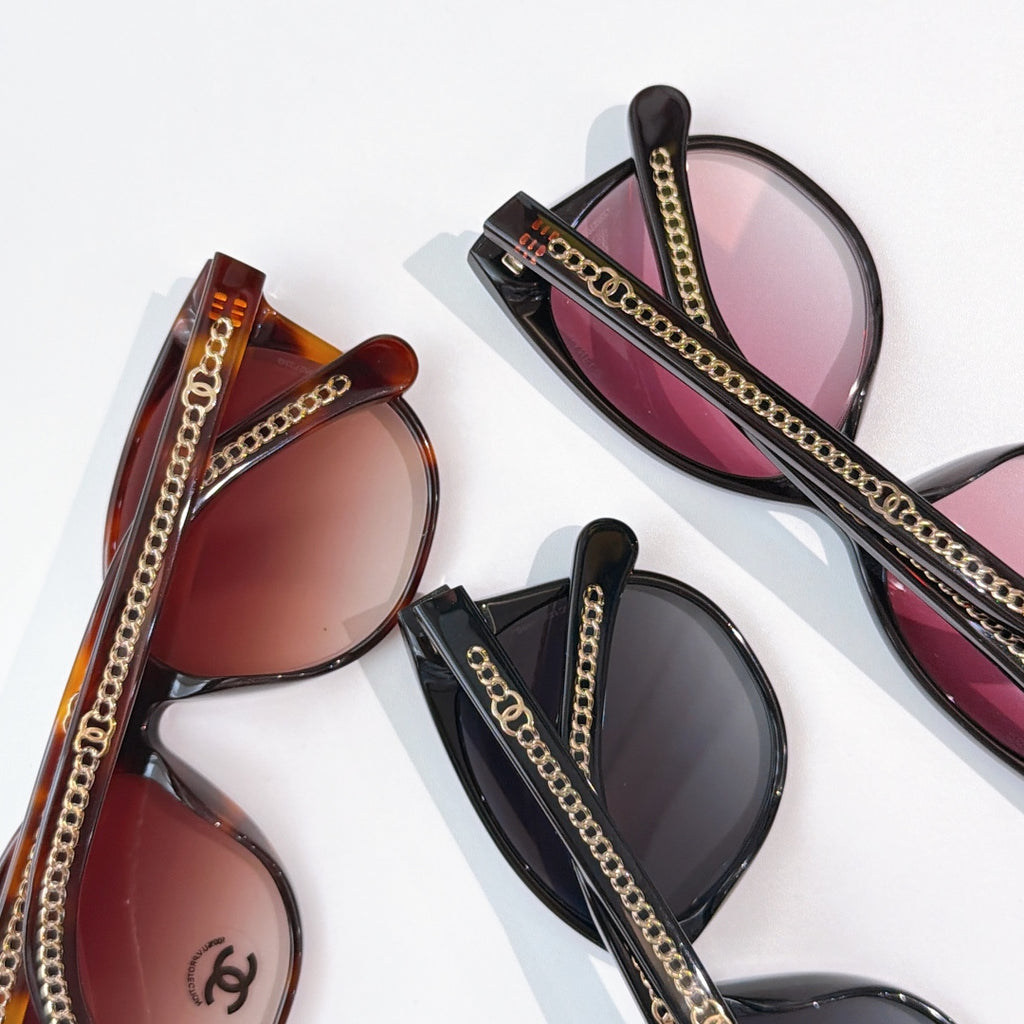 Chanel sunglasses with gold chain trim, dark and tortoiseshell frames with pink lenses
