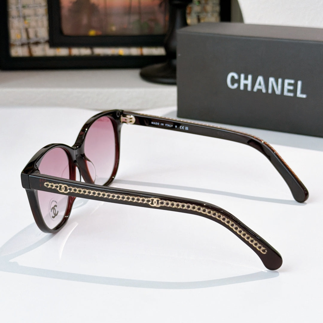 Chanel sunglasses side view with black frames and gold chain trim, tinted lenses
