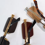 Bottega Veneta glasses close-up of lens fronts and gold temple hardware on multiple pairs.