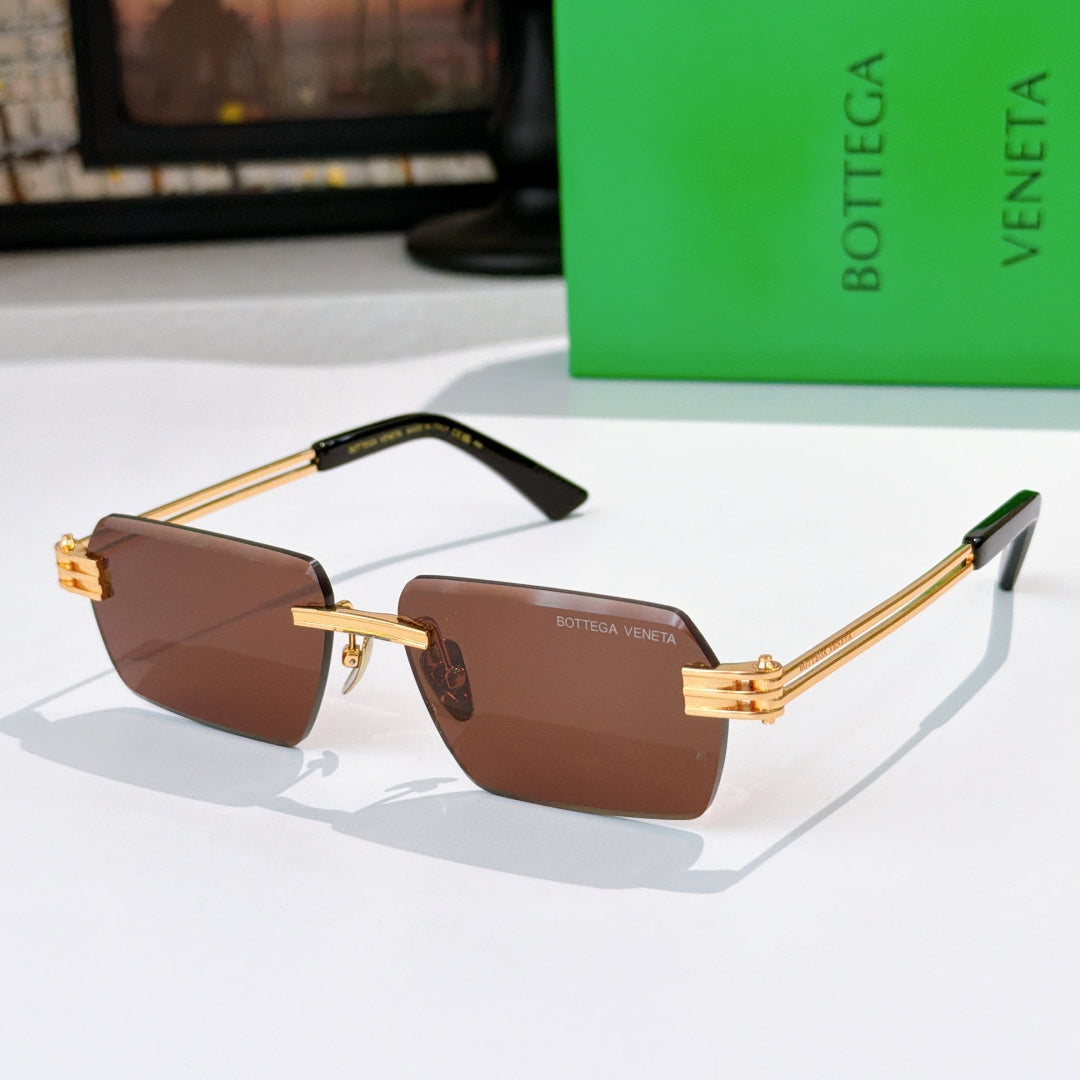 Bottega Veneta glasses with brown lenses, gold temples, black top frame accents.