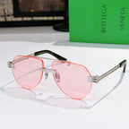 Sunglasses with pink lenses, pink frame, and orange-tinted accents on temples