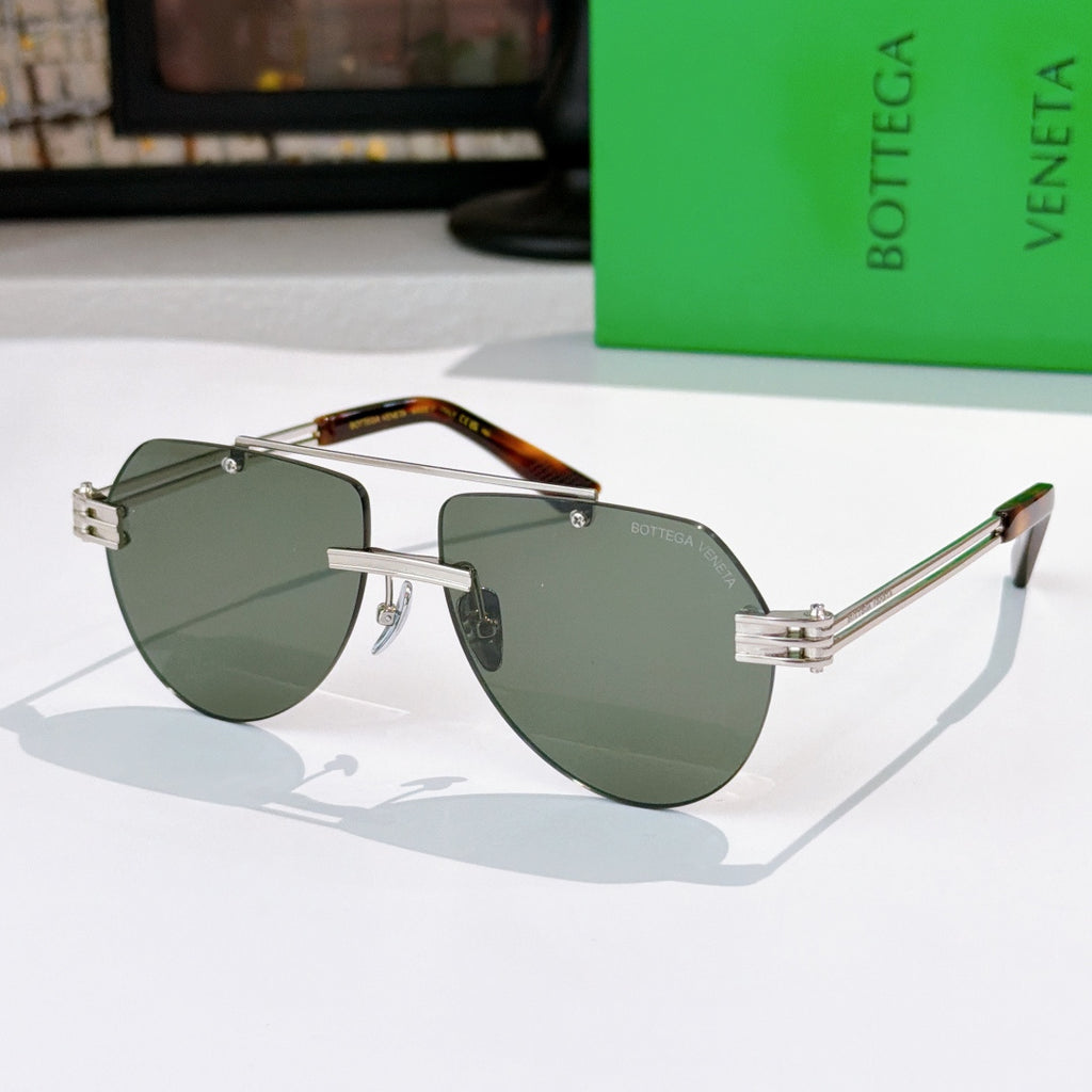 Sunglasses with dark green lenses, silver frame, and tortoise-accent temples