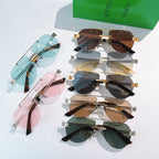 Assorted sunglasses laid out: blue, brown, pink, and green tinted lenses