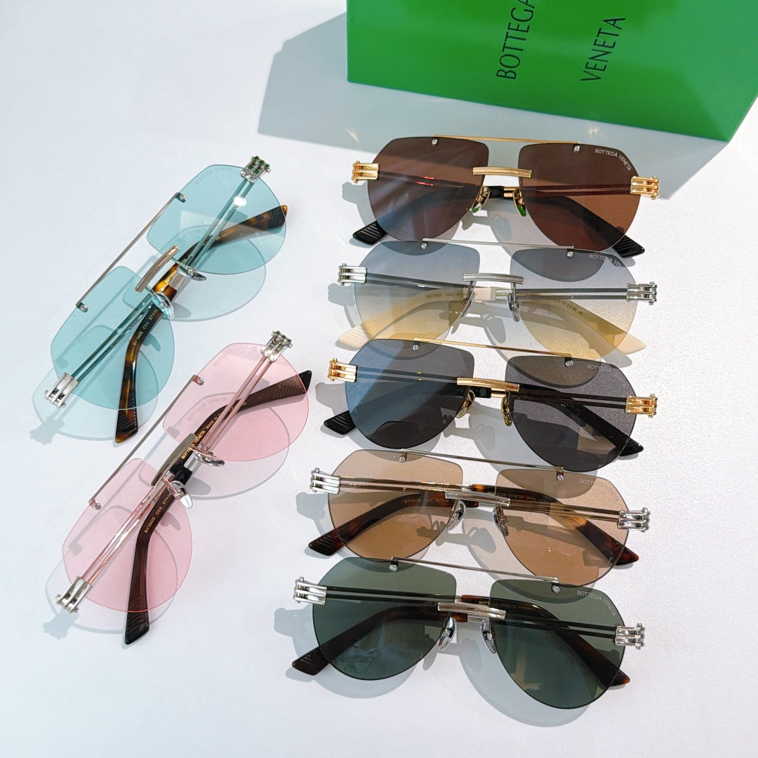 Assorted sunglasses laid out: blue, brown, pink, and green tinted lenses